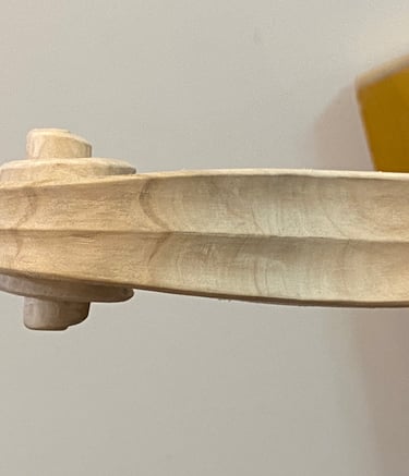Local tone-wood seen here in the white is used for carving the violin scroll