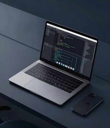 A high-angle photography shot of a sleek, minimalist tech workspace in a Southeast Asian / Indonesian city. A premium laptop displays complex coding and graphic design work. The lighting is clean and professional, incorporating Dark Charcoal Navy and Soft Teal tones from the brand palette.