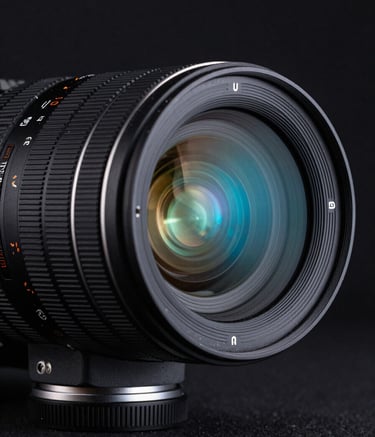 Close-up macro photography of a high-end cinema camera lens reflecting neon blue and cyan lights in a dark, minimalist studio. The atmosphere is sophisticated and technological, representing professional quality and premium growth services.