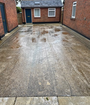 Before and after of a commercial driveway power washed to remove years of grime.