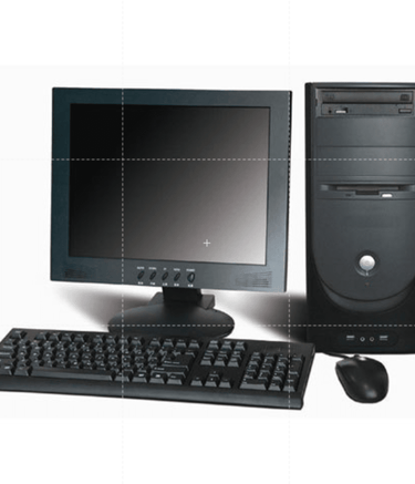 An old computer desktop with a monitor, keyboard, and mouse