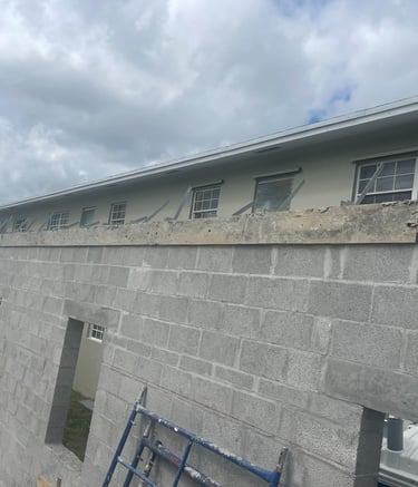 Building block wall with concrete tie beam and inbeeded straps ready for truss install