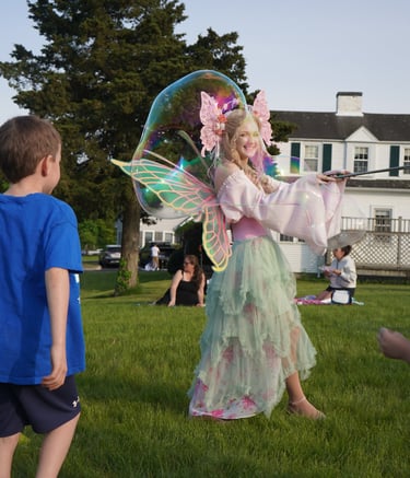 Bubble fairy making bubbles for guests