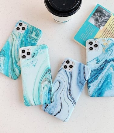 a group of three cell phones with a coffee cup