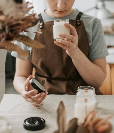 a woman in a brown apron and a vase with flowers