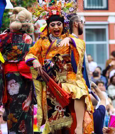a person dressed in traditional Japanese outfit dancing in the Amsterdam Pride Parade