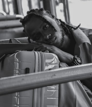 a man with dreadlocks sitting on a bus