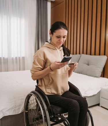 a woman in a wheelchair wheel chair with a cell phone