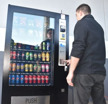 checking the serviceability of a newly installed drinks vending machine by vending machine transport