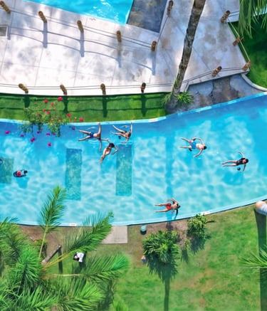 a group of people swimming in a pool