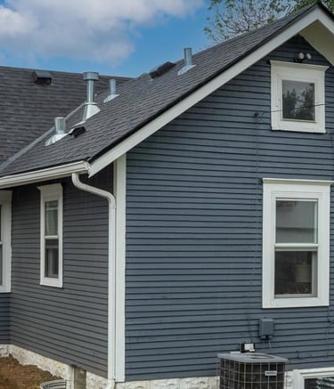 a house with a blue house with a black roof