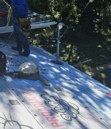 Roofing crew from Golden Hammer Construction installing architectural shingles