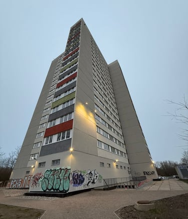 Modernisierte Hochhausfassade mit farbigen Putzflächen – Hebestreit Generalunternehmer