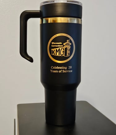 a black and gold mug with a logo on it