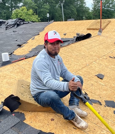 Worker on the damaged roof redeemed-roofing
