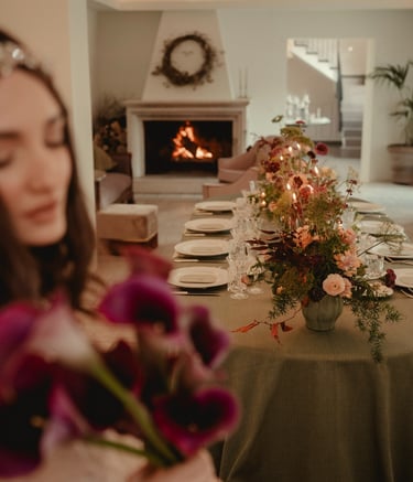 a woman in a white dress is holding a bouquet