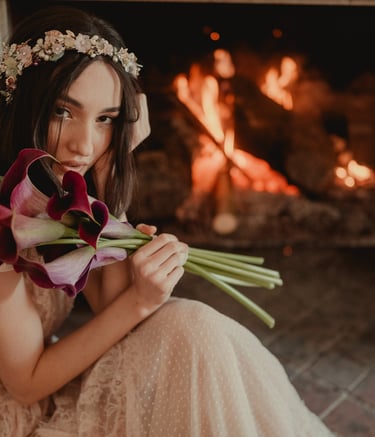 a woman in a dress with flowers in her hands