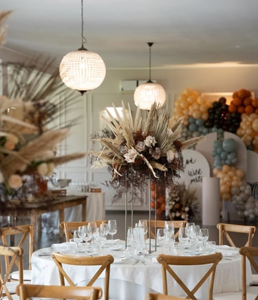a table with a vase with flowers and a vase with flowers