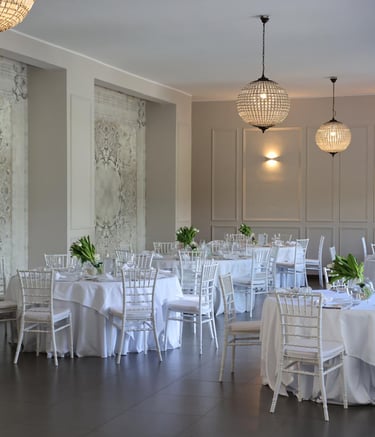 a large room with tables and chairs and a chandelier wedding design