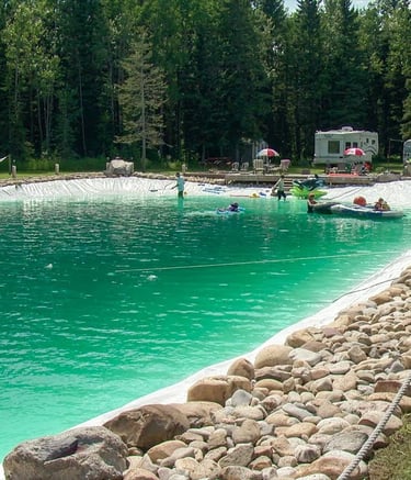 Emerald green natural swimming lake with chemical-free water & public access for rejuvenation & play