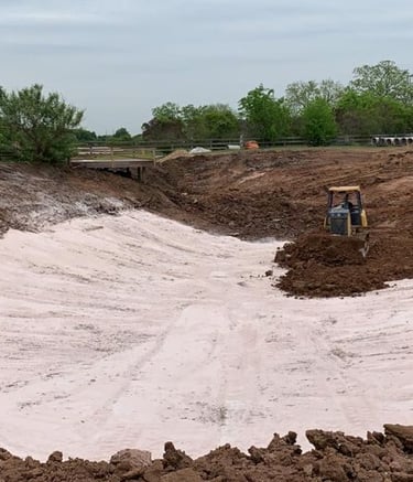Excavator digging natural lake with bentonite clay liner, eco-friendly natural build | Aqua Vitae
