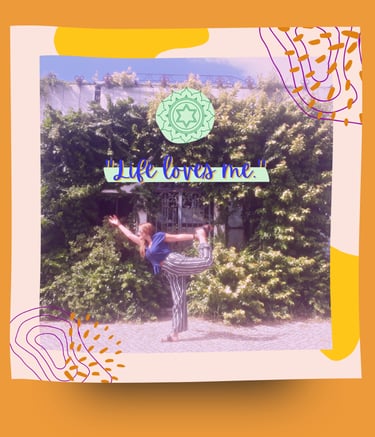 A woman in natarajasana dancer's yoga pose in front of a garden.