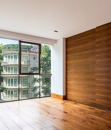 a room with a large window and a wooden floor