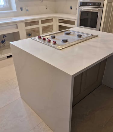 Modern kitchen island with white quartz waterfall countertop
