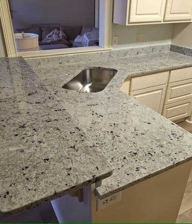 Natural granite countertop with a textured finish and earth tones