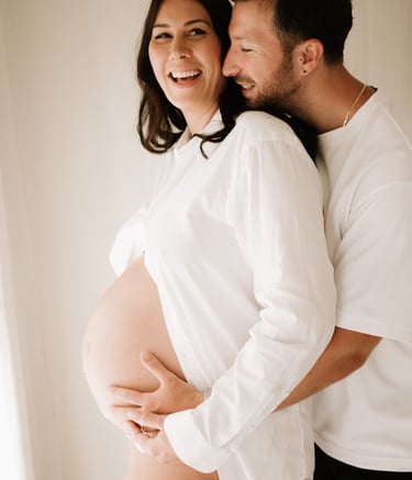 matenrigy couple photo holding baby bump, taken in studio Littlehampton