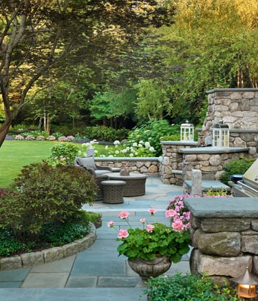 a stone fireplace with a grill and a grill in the background
