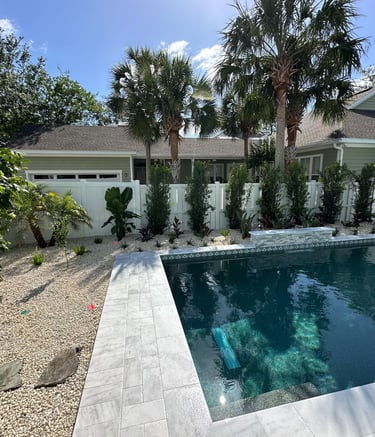 a pool with a pool and a house in the background