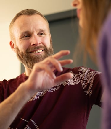 A man clearing energy blockages of a woman