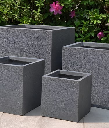 a group of four square concrete planters