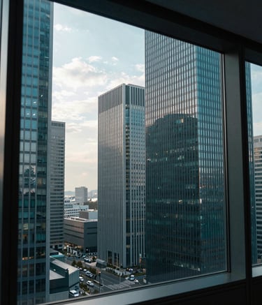 A wide photography of a modern East Asian / Japanese business district skyline seen through a clean office window, morning light, reflecting a sense of dedicated support and professional efficiency, dark teal tones.