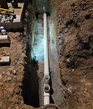 a manholed pipe with a pipe in the middle of a trench