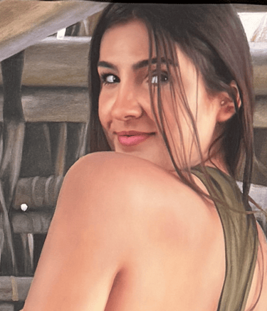Realistic portrait drawing of a smiling woman looking over her shoulder against a rustic wooden background.