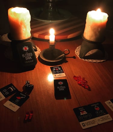 A creepy candle lit layout of The Blessed Darkl board game