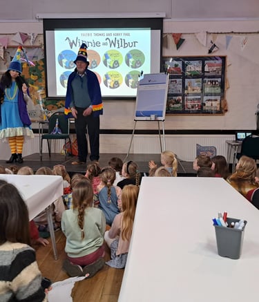 Korky Paul visits with Winnie the Witch on stage