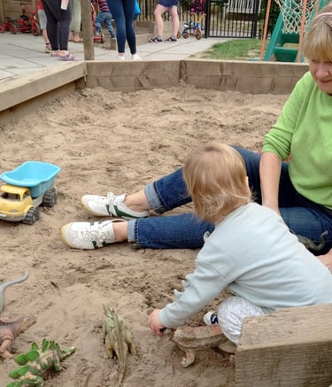 stay and play in the sand pit with volunteer members, children and their carers