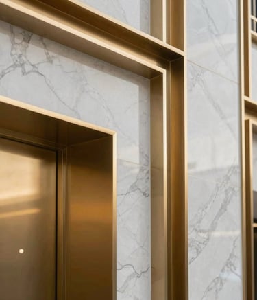 A professional close-up of high-quality architectural finishes, featuring metallic gold accents and premium marble, showcasing the elite standards of a Middle Eastern / Gulf construction project. Modern corporate lighting.