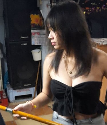 Thai woman playing pool at bar near Soi Bintabaht in Hua Hin