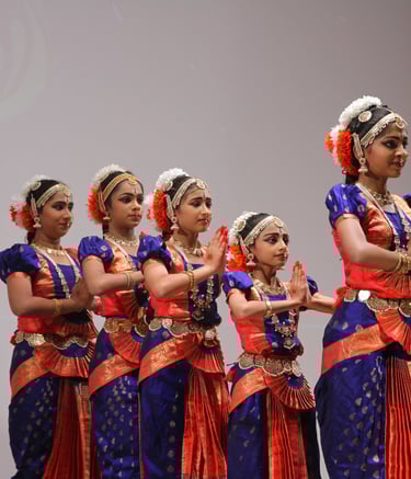 5 bharatanatyam students, standing in line, before the next step and movement.