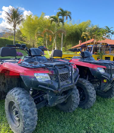 a couple of atvs parked in the grass
