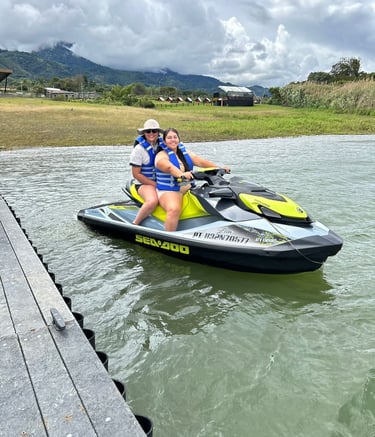 a woman and a man riding a jet skis