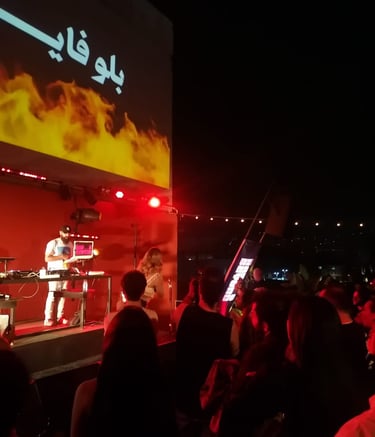 man standing in front of a screen with a video screen in a performance sound engineering for artist