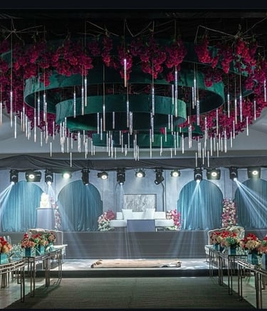 “White wedding stage decor with chandelier ceiling and floral table designs by Milano Event”