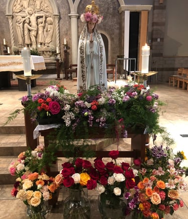Our Blessed Mother at May Crowning surrounded by flowers