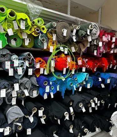a display of many different colorful fabrics