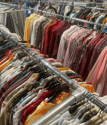 a rack of clothes and clothes hanging on a rack
